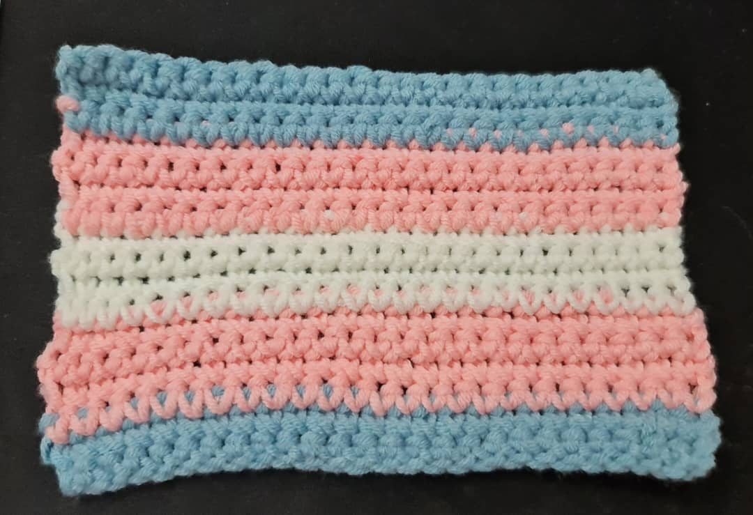 A trans rights flag made with crochet